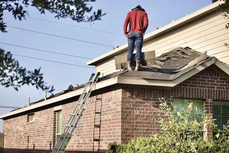 Professional roofer working on a residential roof in Trimble Fields